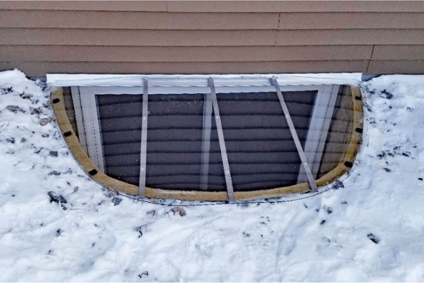 semicircle window well cover in snow